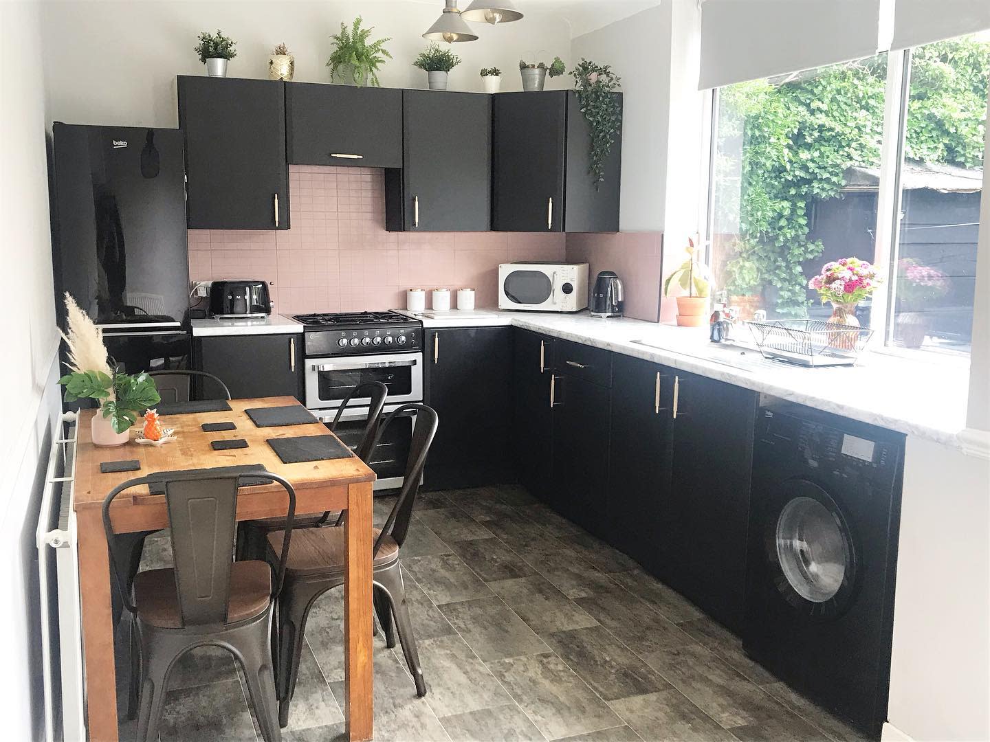 small kitchen wood table and chairs black cabinets slate tile floor